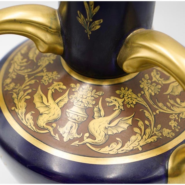 A Ceramic over glass vase from the Art Nouveau period features in an overall brown to green ground hue ceramic embeliished...