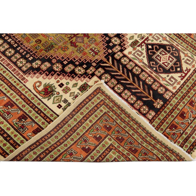 Beautiful Vintage Persian hand-knotted Wool rug with the ivory field. This Persian rug has a multicolor accents in all...