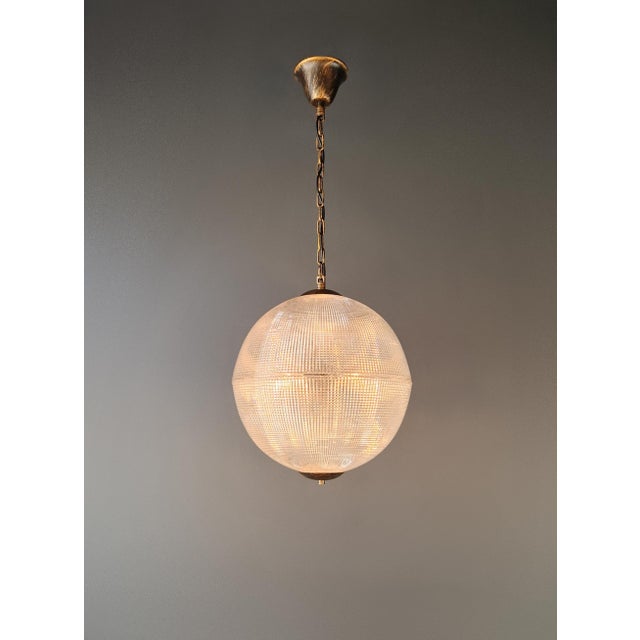 Inspired by the distinctive glow of historic Parisian streetlights, this large globe pendant light is a contemporary...