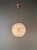 Inspired by the distinctive glow of historic Parisian streetlights, this large globe pendant light is a contemporary...