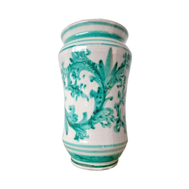 A rare vase crafted by Igor Santo Stefano Di Camastra. It is a tall round ceramic vase that features a white background...