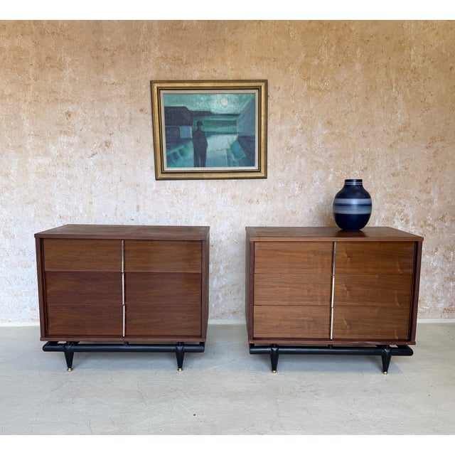 A handsome pair of American mid-century modern walnut chests by Kent Coffey from the “The Sequence” collection, circa...