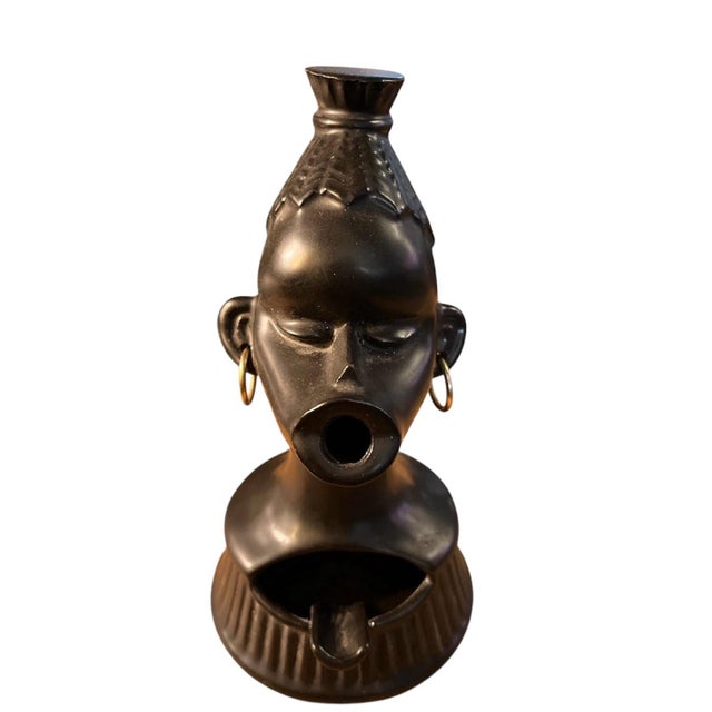 This striking mid-century ceramic head ashtray showcases an expressive sculptural form inspired by African artistry and...