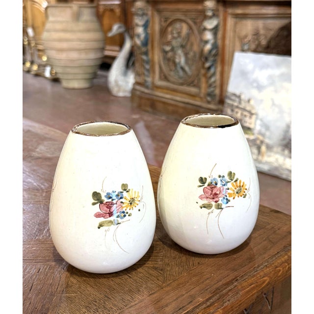 Add a charming French accent to a tabletop, mantel, or shelf with this colorful pair of vintage ceramic vases. Crafted in...