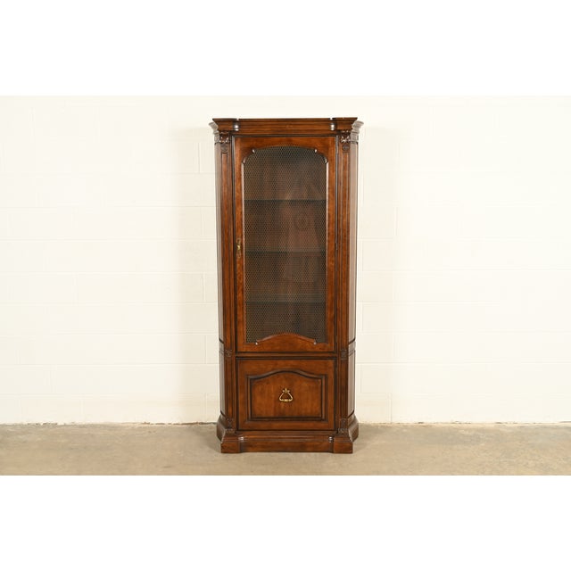 A gorgeous French Regency Louis XVI or Neoclassical style lighted bookcase, display cabinet, or dining cabinet By Davis...