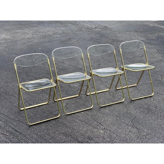 A rare set of brass and Lucite Italian, 1970s folding chairs in the style of Giancarlo Piretti. These chairs were usually...