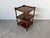 A charming vintage English three-tier side table crafted with elegantly turned legs and a raised gallery top. Its compact...