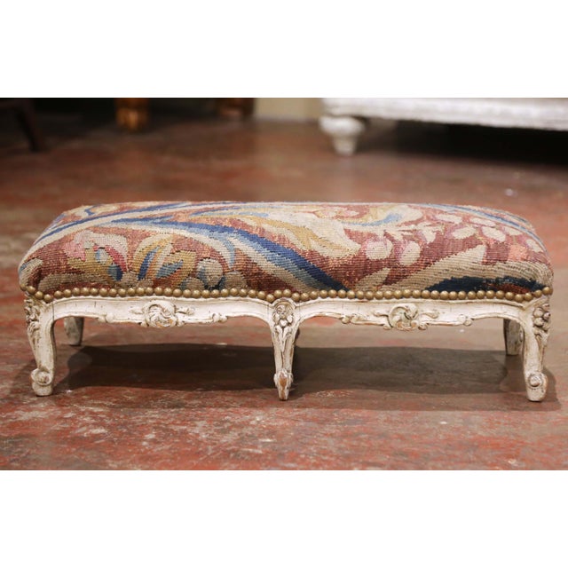 Add authentic French character and rich textile color to an interior with this elegant antique footstool. Crafted in...