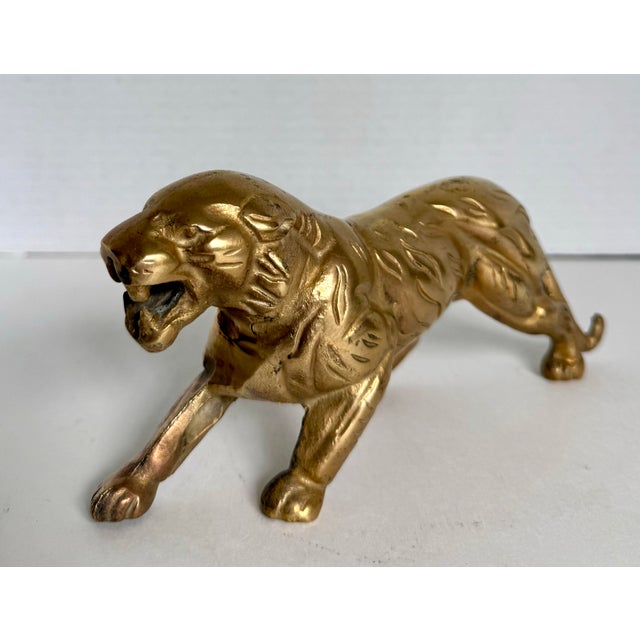 Here is a vintage solid brass tiger sculpture dating to the mid-20th century. Captured mid-stride with an open mouth and...