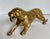 Here is a vintage solid brass tiger sculpture dating to the mid-20th century. Captured mid-stride with an open mouth and...