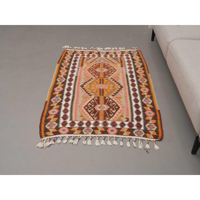 Vintage Hand-Knotted runner rug is a semi-antique vintage area rug. The '70s Eastern region of Anatolia's unique rug is...