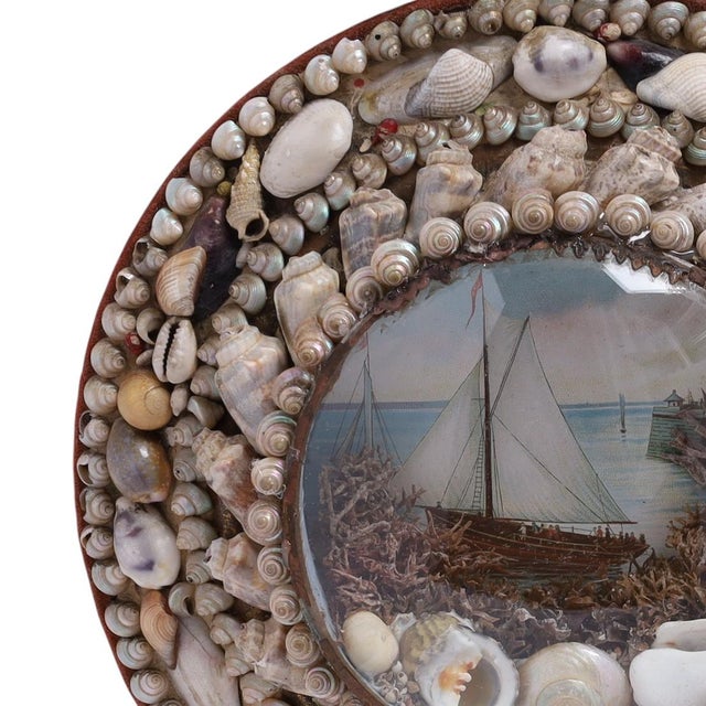 Charming 19th Century round Sailors Valentine ambitiously handcrafted with exotic seashells around images of a sailing...