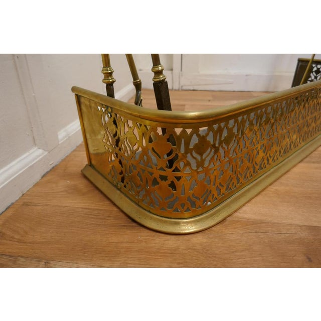 Victorian Pierced Brass Fender with Fire Irons This is a Victorian Pierced Brass Fender, on either side it has a support...