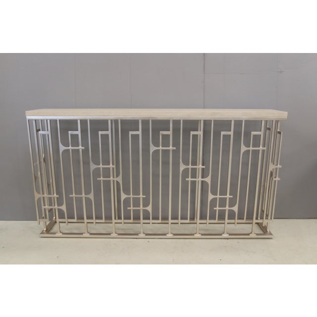 Another distinctly different console design within the collection offers both form and function. The Anticato marble top...