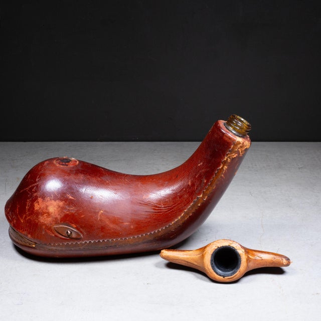 ABOUT A mid-century leather-wrapped whale decanter. Handcrafted in Italy, this barware piece features stitched rich brown...