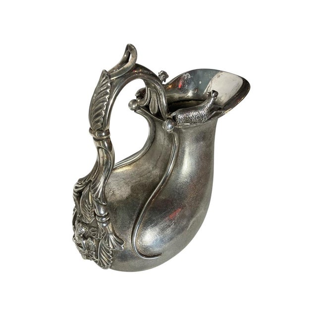 Sterling silver askos jug, a specific style of antique pitcher. It is modeled to resemble an ancient greek vessel made...