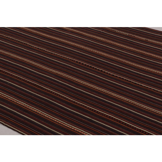 Made with handwoven wool circa 1950-1960, this 6x7 vintage flat-weave Kilim is a particularly elegant and sought-after...