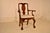 18th century mahogany Queen Anne arm chair from England. The top rail on the back has a central scroll, continuing in...