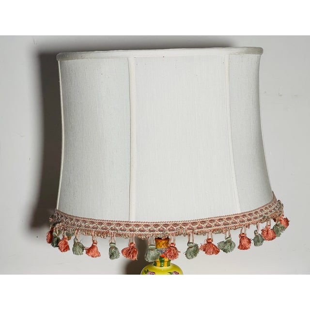 Vintage oval lamp shade decorated with tasselated fringes.