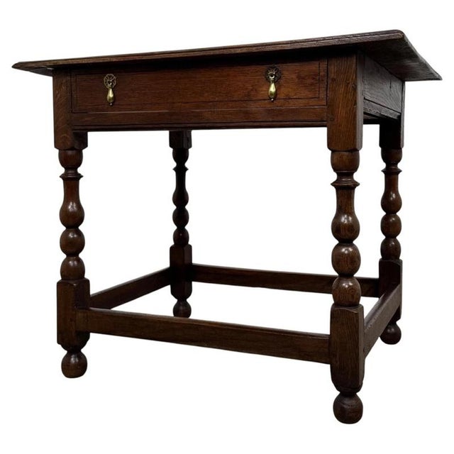 A handsome 18th-century English Georgian side table, finely crafted from oak and distinguished by its beautifully executed...