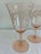 A charming set of four vintage pink wine glasses featuring an etched grape and vine motif. The soft blush tone paired with...