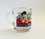 A vintage 1970s Garfield and friends glass mug. Features a colorful printed design. Originally made for McDonalds.