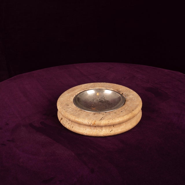 Overview A sculptural round ashtray in warm Italian travertine, 1970s, fitted with a removable polished metal dish. A...