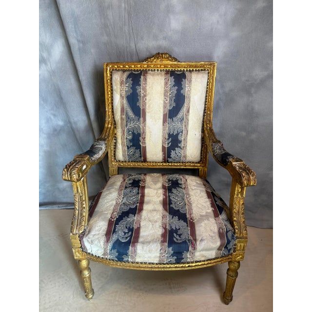 Italian design carved giltwood armchair, the cresting rail carved with scrolled foliage over foliate carved platform,...