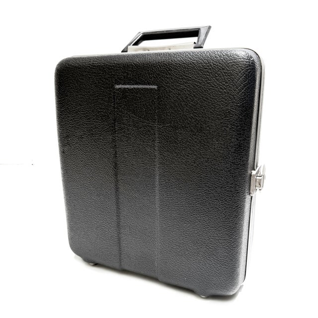 This is a vintage portable traveling bar kit housed in a textured black hard-shell case with silver-tone hardware and a...