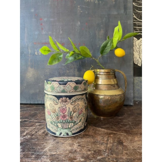 Gorgeous Asian, ceramic, presented in a cylindrical shape that has been painted a deep, midnight blue, across the blue are...