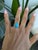 A Sleeping Beauty turquoise in a clean, robin's-egg blue is bezel-set at the centre of this solid 14K yellow gold split-...