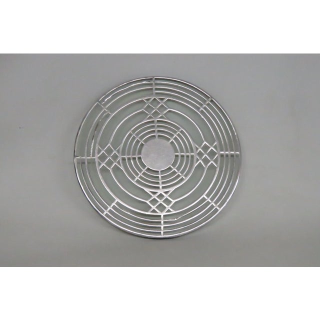 This lovely Round Trivet is silver plated and made of glass. This gorgeous kitchen / dining table accessory presents an...