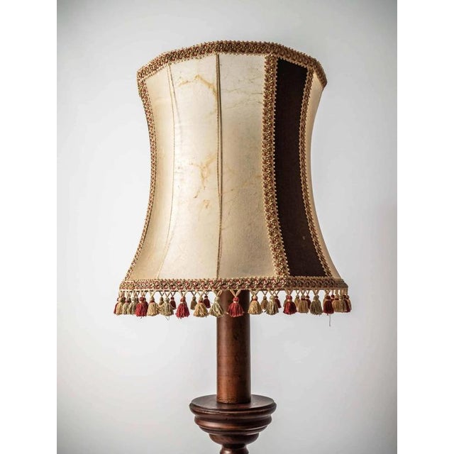 Massive and sturdy wooden lamp with a richly turned leg. The lampshade is covered with cowhide combined with fine mohair...