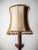 Massive and sturdy wooden lamp with a richly turned leg. The lampshade is covered with cowhide combined with fine mohair...