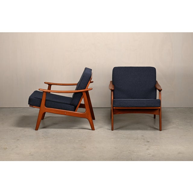 A pair of Scandinavian Modern armchairs, Denmark, 1960s. The frames are made of solid teak and are in very good condition....