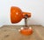 This orange wall light was produced by Lidokov in former Czechoslovakia during the 1970s. The lamp has a iron wall...