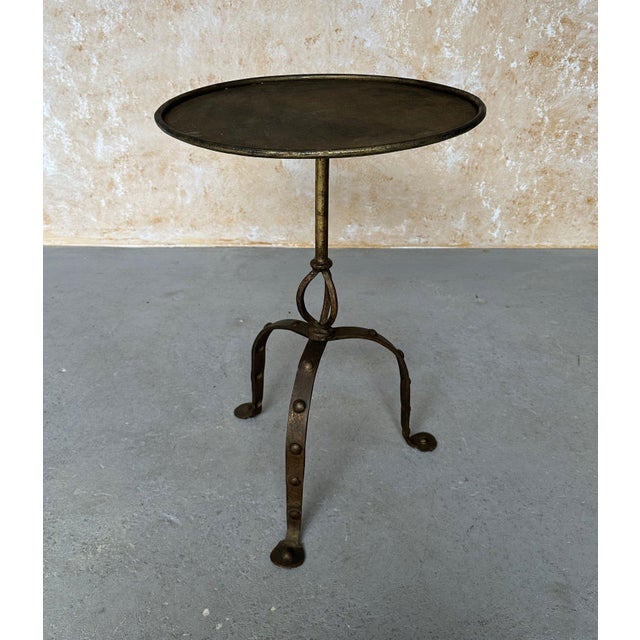 This large Spanish iron side table from the 1950s is a unique piece of vintage furniture. Measuring 26 inches in height...
