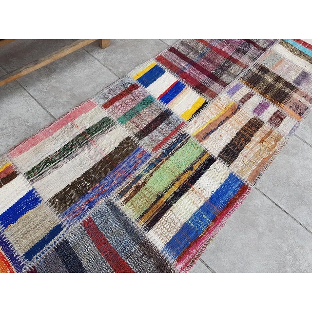 This is a vintage Turkish Oushak rug from the Mid 20th Century. The piece was hand-knotted.