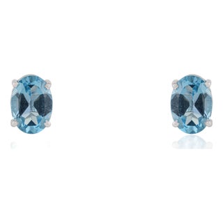 Classic 5x7mm Oval Blue Topaz Four Prong Stud Earrings in 925 Sterling Silver - A Pair For Sale