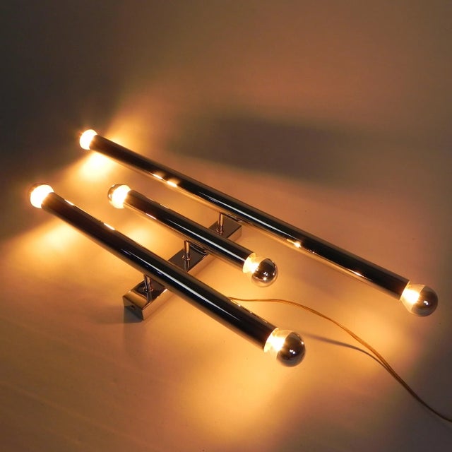 This beautiful wall lamp consists of three chrome-plated tubes, each ø 3.5 cm, measuring 25, 45, and 65 cm in length. it...