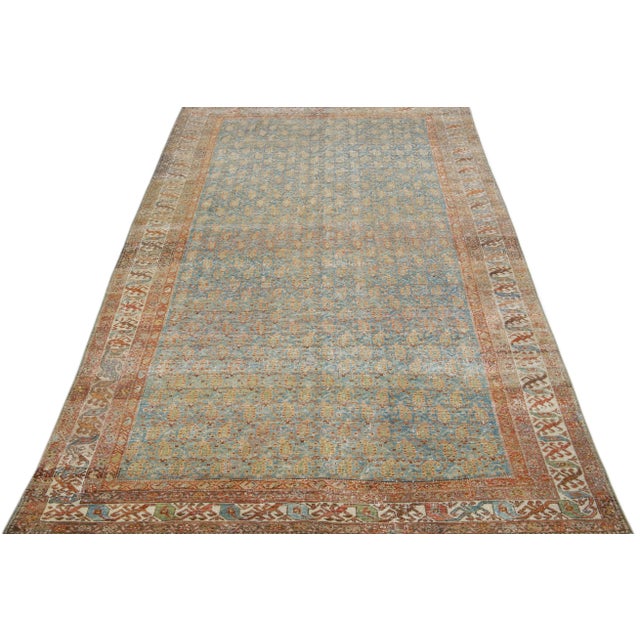 Beautiful antique Malayer hand-knotted wool rug with a blue color field. This Persian rug has orange-rust, brown, and...