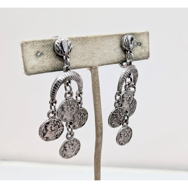 1970s rhodium plated round textured top with ribbed half moon with 2 alexander the great "coins" hanging from the center...