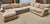 A large four-piece sectional with a contemporary profile and neutral beige upholstery. The set provides generous seating...