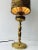 Unique antique 1930s brass lamp with original Victorian shade. The lampshade displays a romantic scene in a forest area. A...