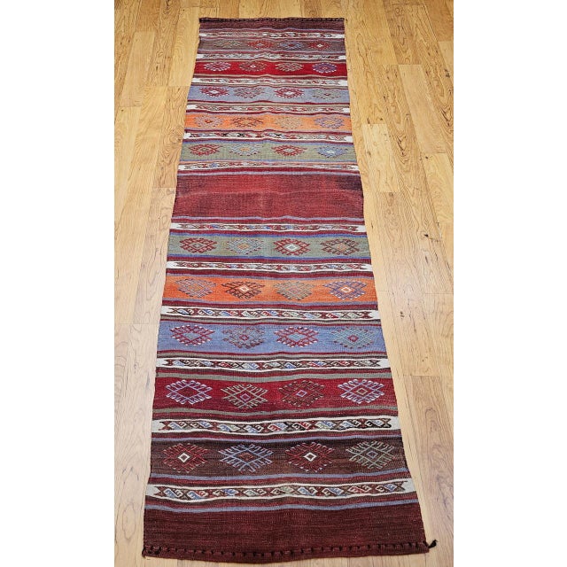 Discover the vibrant artistry and captivating spirit of North African weaving with this beautiful Mid-20th Century Vintage...