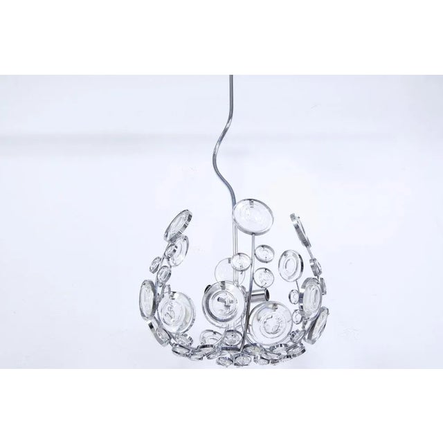 Particular design and production chandelier of the 1970s in complete Space Age style. Steel structure with curved auction...