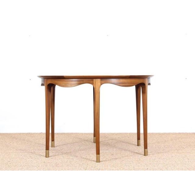 Mid-century modern elegant ole wanscher coffee table in walnut. The circular top with a softly curved apron, above six...