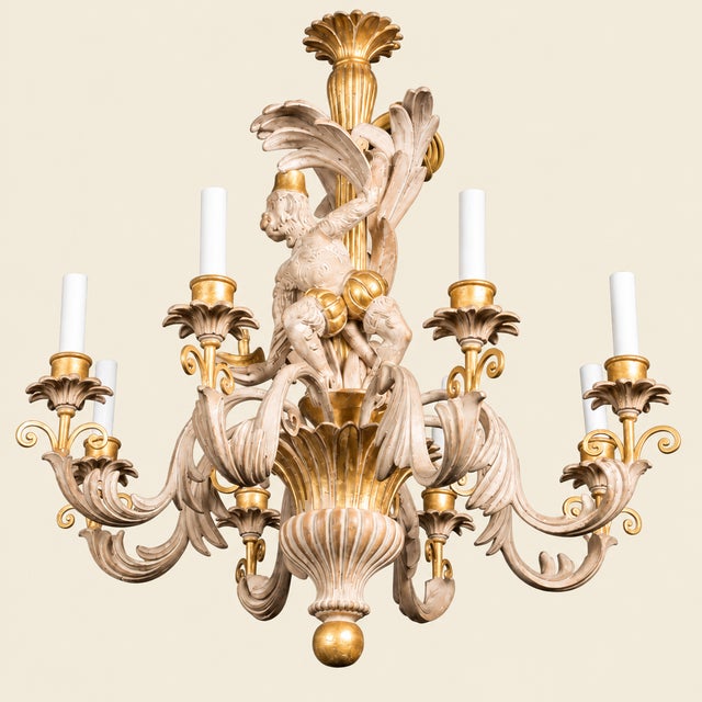 Elevate your space with this stunning vintage 1970s Italian monkey chandelier, masterfully carved from solid wood and...