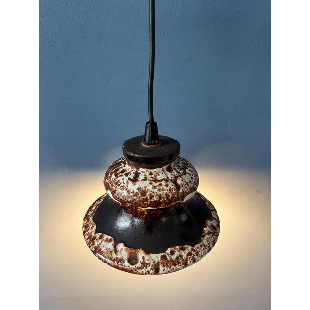 Brown west germany ceramic fat lava pendant lamp. The light spreads a nice warm glow through the holes in the ceramic...