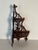 Beautiful light and elegant corner display shelf unit with fret work on wood.